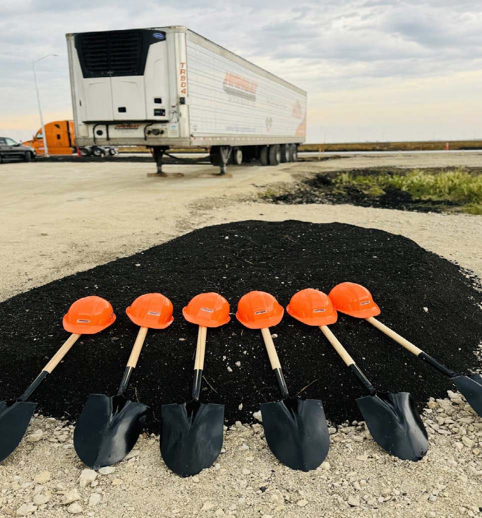 6 Highway Motor Freight helmets with shovels in front of temperature-controlled trailer at Manitoba, Winnipeg facility location 